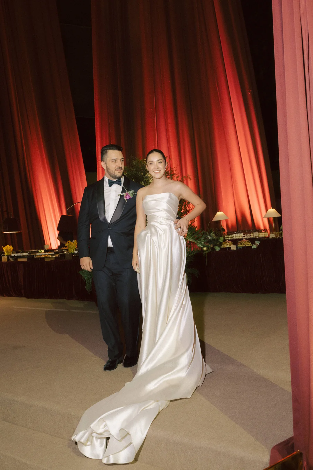 Manuela and Juan Pablo under the burgundy drapes