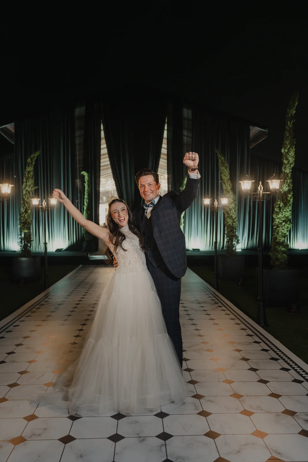 Couple on a dramatic black aisle
